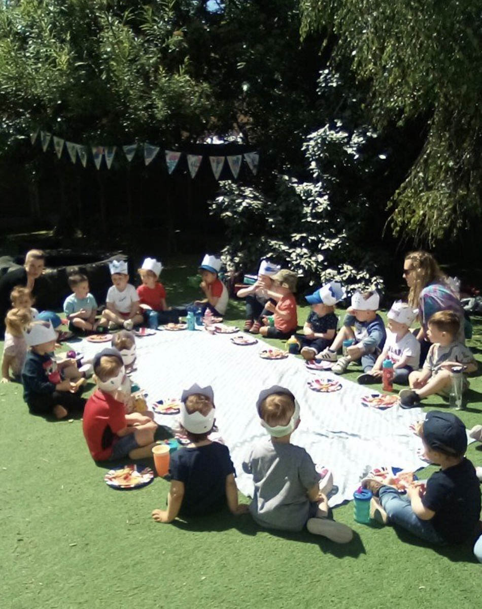 A member of the playaway day nursery team and a child at the nursery graduation
