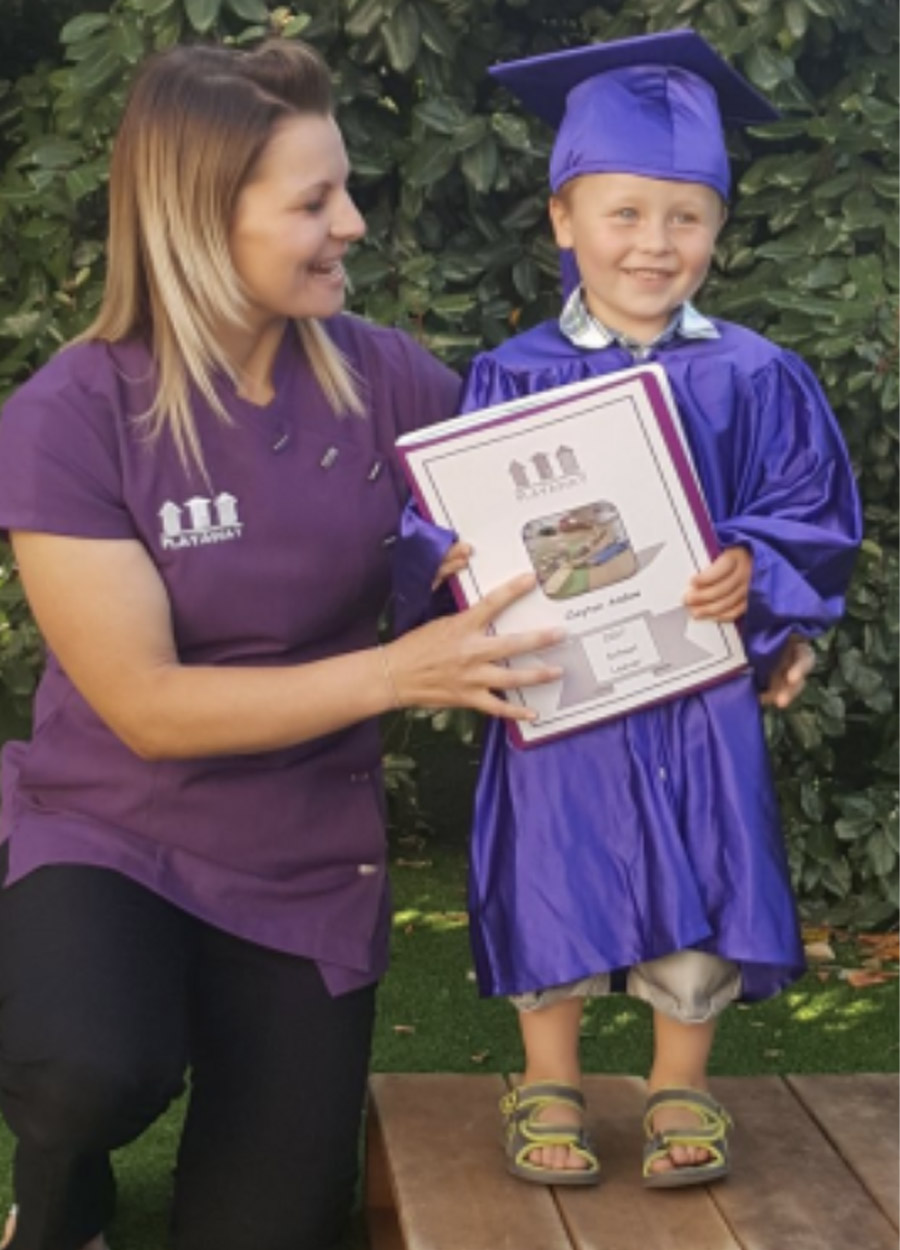 A member of the playaway day nursery team and a child at the nursery graduation